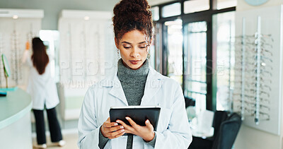 Buy stock photo Tablet, woman and optometrist in shop for vision, eyecare or wellness report online. Reading, research and female optician with digital technology for checking ophthalmology appointment in store.
