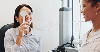 Buy stock photo Eye test, check or cover with women in clinic with diagnostic tool for prescription lens or help. Service, depth perception or optometrist in vision assessment with person, optician or visual exam
