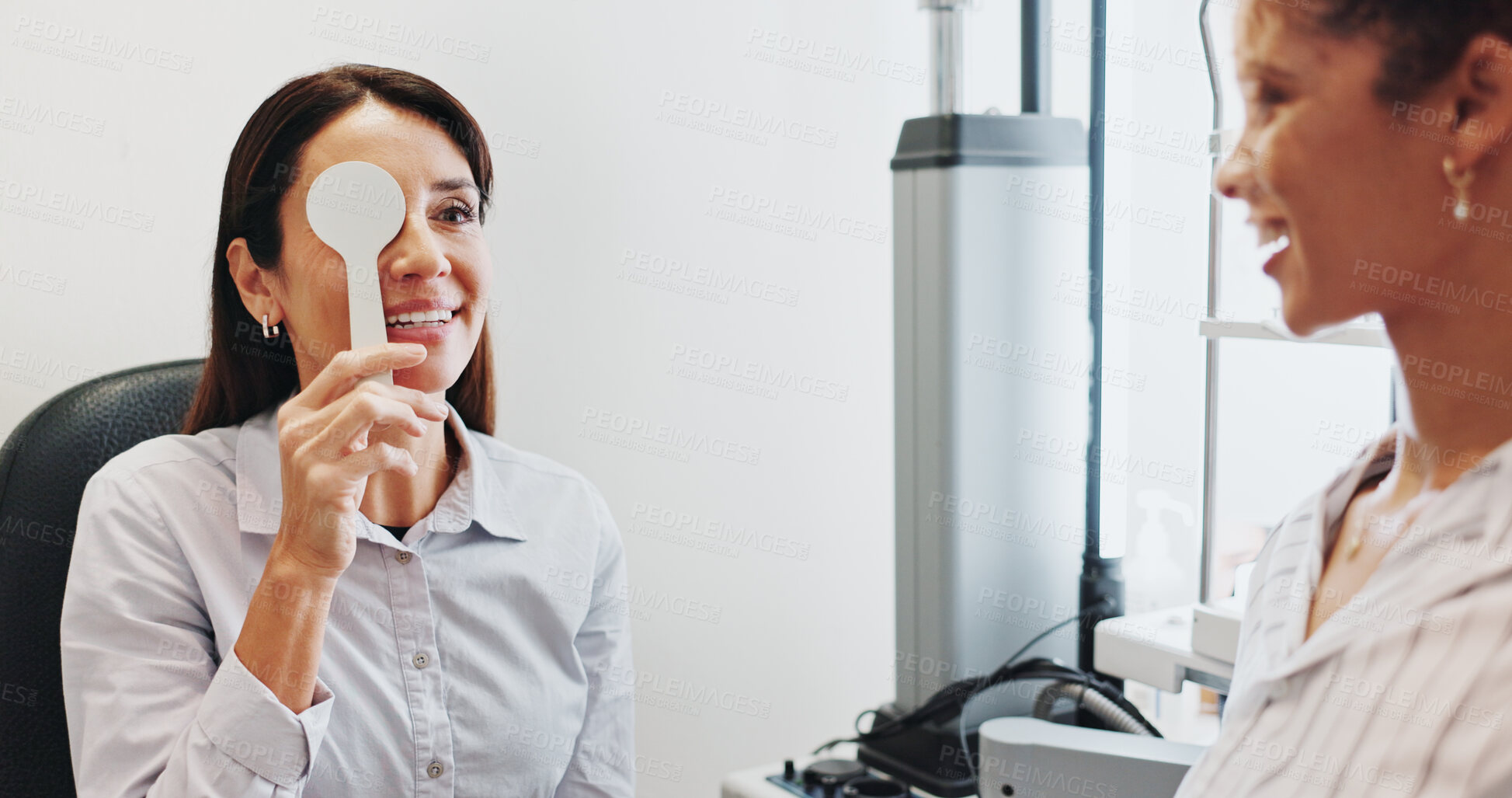 Buy stock photo Eye test, check or cover with women in clinic with diagnostic tool for prescription lens or help. Service, depth perception or optometrist in vision assessment with person, optician or visual exam