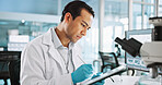 Scientist, man and tablet with digital notes for biology, breakthrough or medical research analysis. Biotech, laboratory and microscope with DNA study for pharmaceutical RNA or pathology experiment