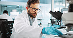 Scientist, man and medical research with microscope at lab with sample, review and glasses for pharma job. Person, gloves and equipment with process for vaccine innovation, trial and clinical study