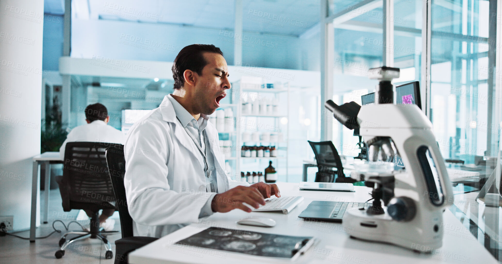 Buy stock photo Laptop, science and tired with man in laboratory for healthcare, medical or pharmaceutical innovation. Computer, fatigue and microscope with scientist yawning in clinical trial for development