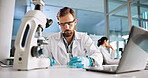 Scientist, man and chemistry with laptop for research, breakthrough or medical notes analysis. Biotech, laboratory and microscope with DNA for pharmaceutical RNA study or chemical experiment project