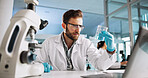 Scientist, man and chemistry with laptop for analysis, breakthrough or medical notes research. Biotech, laboratory and microscope with DNA for pharmaceutical RNA study or chemical experiment project