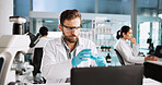 Scientist, man and chemistry with laptop for project, breakthrough or medical notes research. Biotech, laboratory and microscope with DNA for pharmaceutical RNA analysis or chemical experiment study