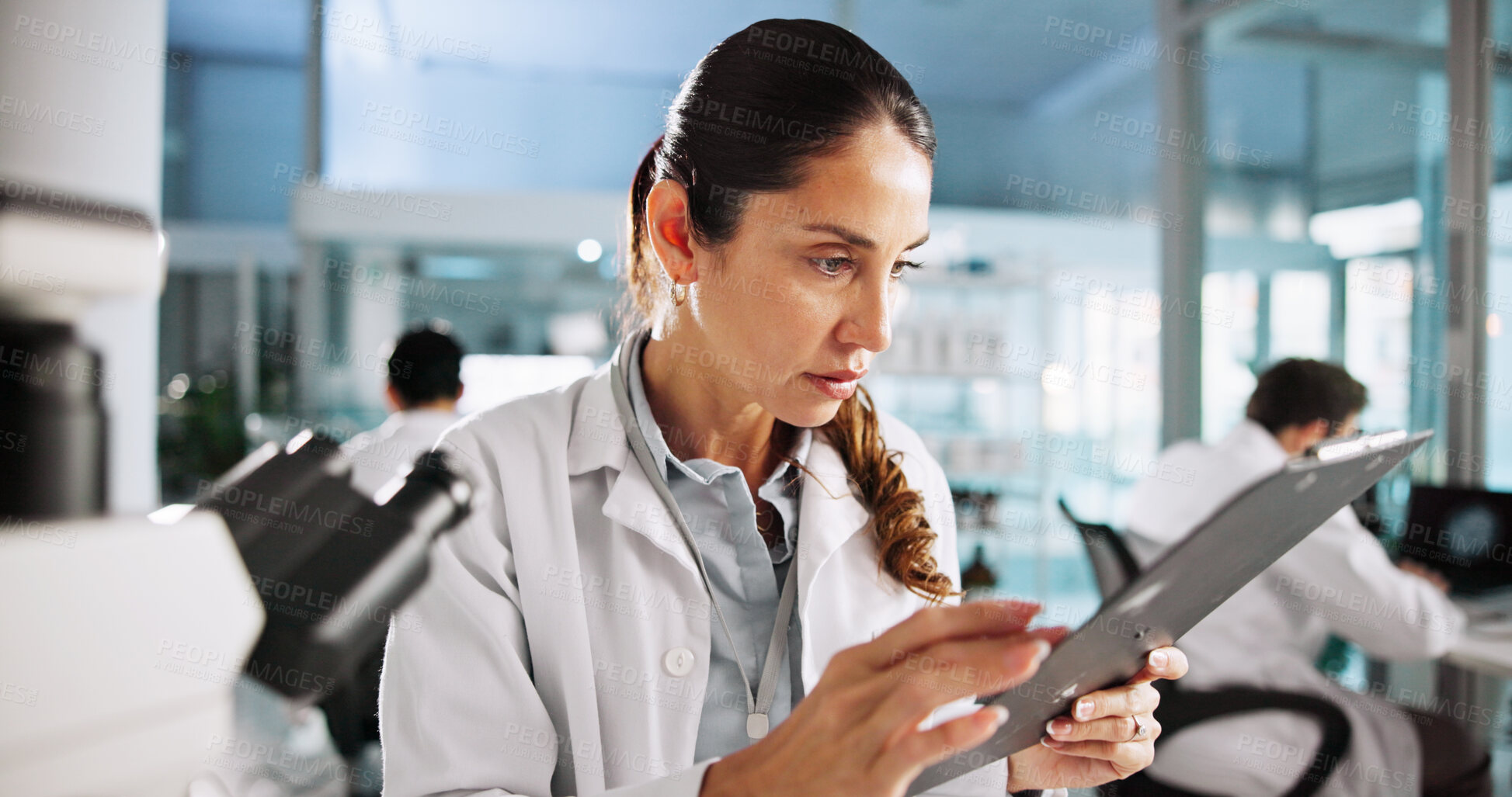 Buy stock photo Scientist, woman and clipboard with study for biology, feedback or medical notes analysis. Biotech, laboratory and microscope with DNA research for pharmaceutical RNA or bacteria experiment project