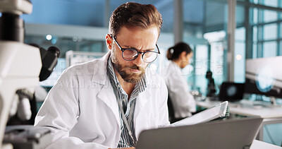 Buy stock photo Reading, laptop and research with man in laboratory for clinical trail, online and science. Medical journal report, review and pharmacy drug development with person for healthcare and biotechnology