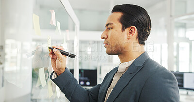 Buy stock photo Writing, planning and man with ideas, office or info for strategy in corporate company or glass. Serious, banker and person with sticky notes for potential investment or financial growth for business