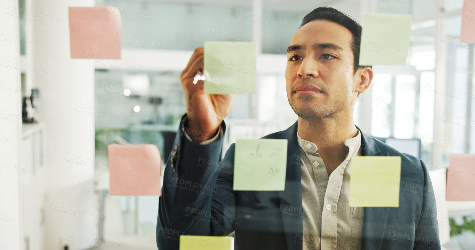 Buy stock photo Creative, man and writing on sticky notes by glass wall for campaign planning, budget development and ideas. Marketing manager, employee and calendar tasks for project management or business strategy