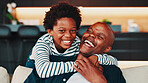 Hugging, laugh and portrait child with father in home for trust, safety or care in living room. Love, sweet and kid embracing dad for protection, connection or bonding on weekend with family in house