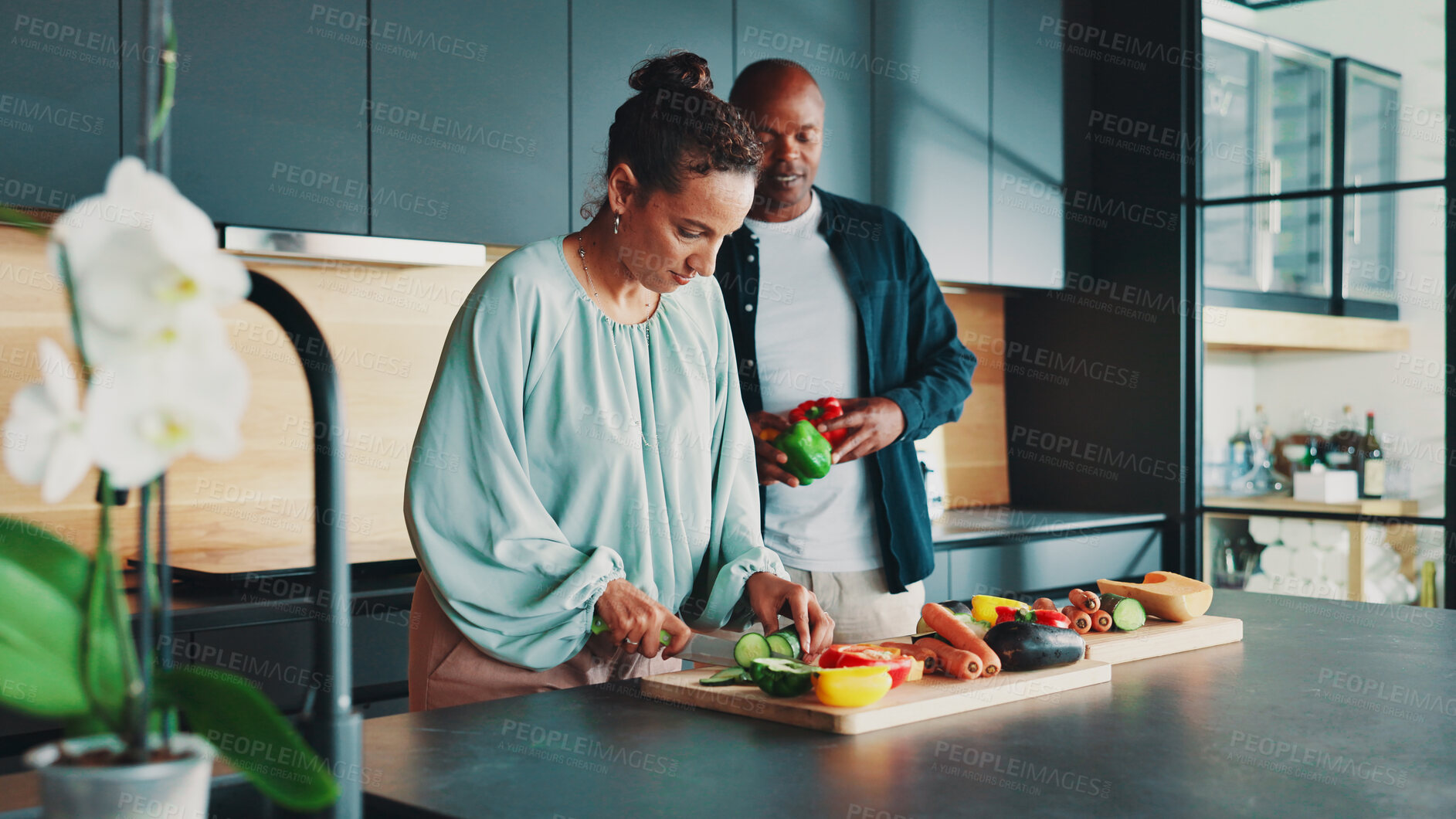 Buy stock photo Mature couple, help and cooking in kitchen with vegetables, knife and support with meal prep in home. People, man and woman with ingredients, cutting board and together for food, diet or nutrition