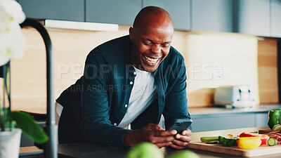 Buy stock photo African man, phone and laugh with cooking in kitchen for vegetables, happy or click for recipe. Mature person, smartphone and meme on mobile app for tutorial video for food, diet or nutrition in home