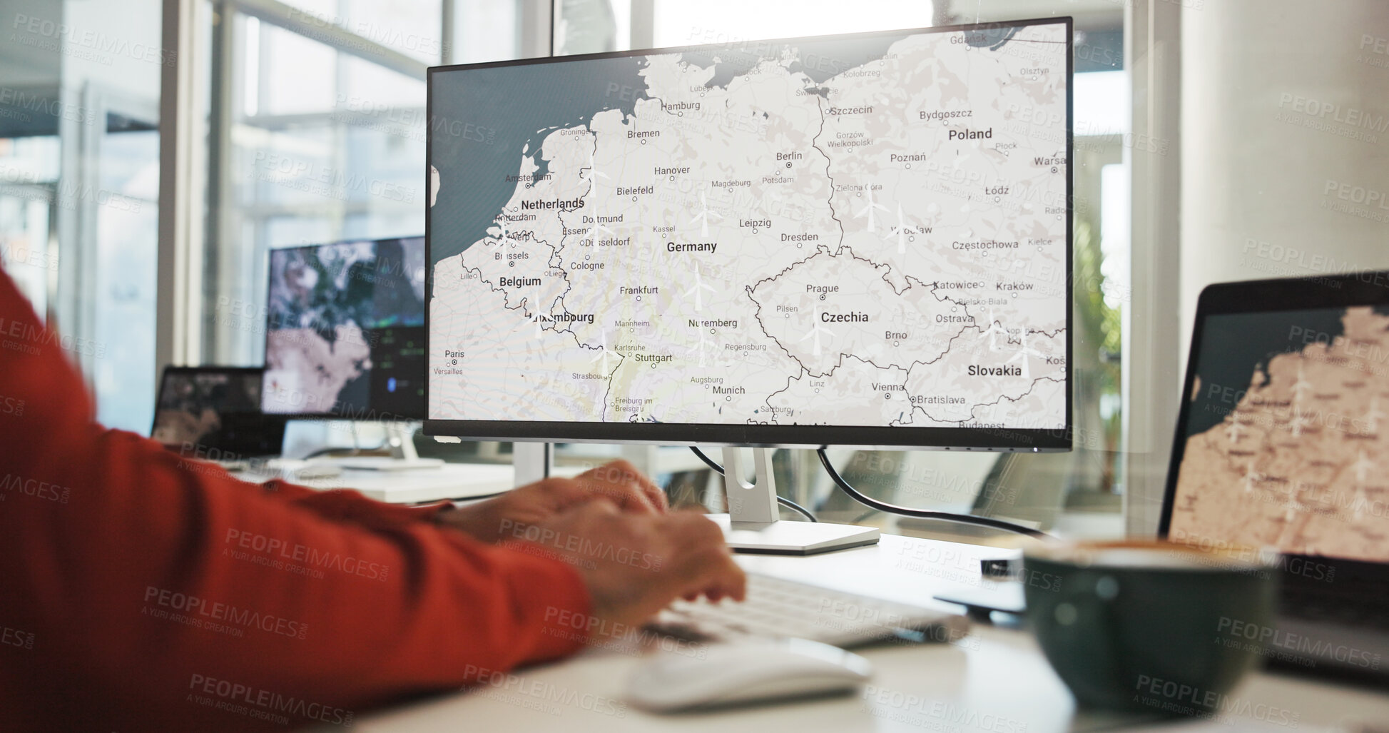 Buy stock photo Computer screen, hands and wind turbine with business person in office for renewable energy or sustainability. Electricity, typing and windmill with map on display for development or engineering