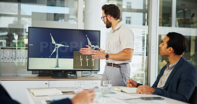 Buy stock photo Businessman, meeting and screen with presentation for renewable or clean energy at conference. Man, employee or speaker talking to group with technology display of wind turbine for eco development