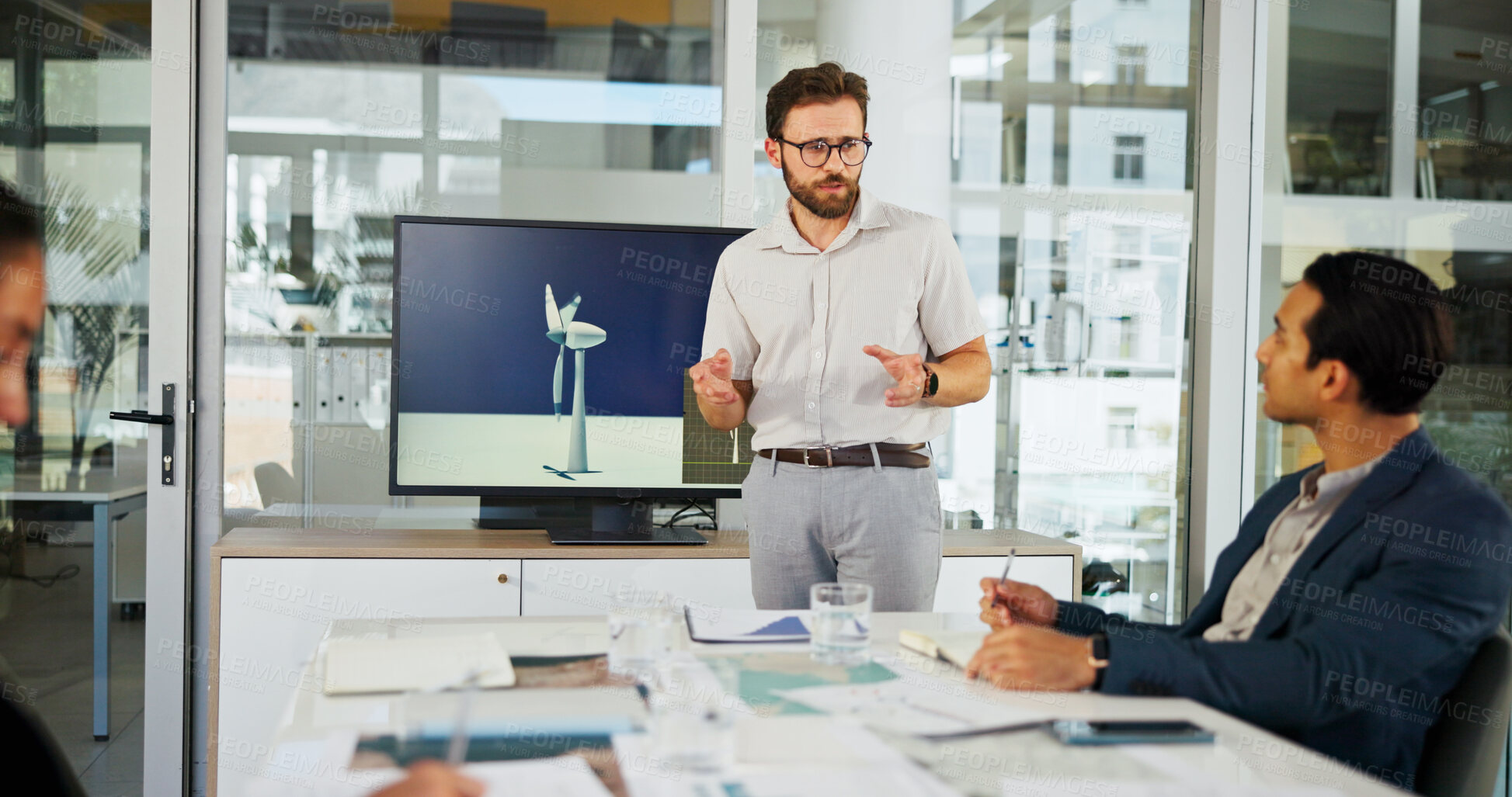 Buy stock photo Businessman, meeting or presentation with documents for renewable or clean energy at conference. Man, employee or speaker talking to group with proposal for wind turbine or eco development at office