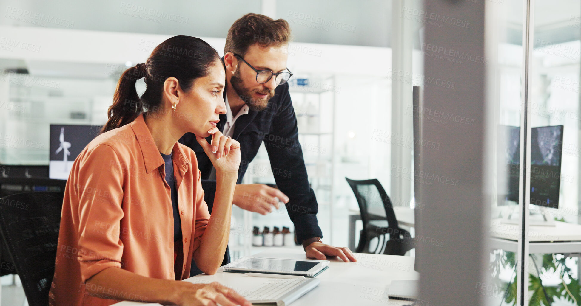 Buy stock photo Meeting, sustainability and business people on computer in office for project, research and planning. Discussion, thinking and man and woman on pc for wind turbine, electricity and renewable energy