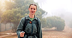 Woman, hiking and happy with portrait in woods, outdoor and adventure on holiday, trekking and countryside. Girl, person and smile with pride in nature, forest and fog in winter for trail in England
