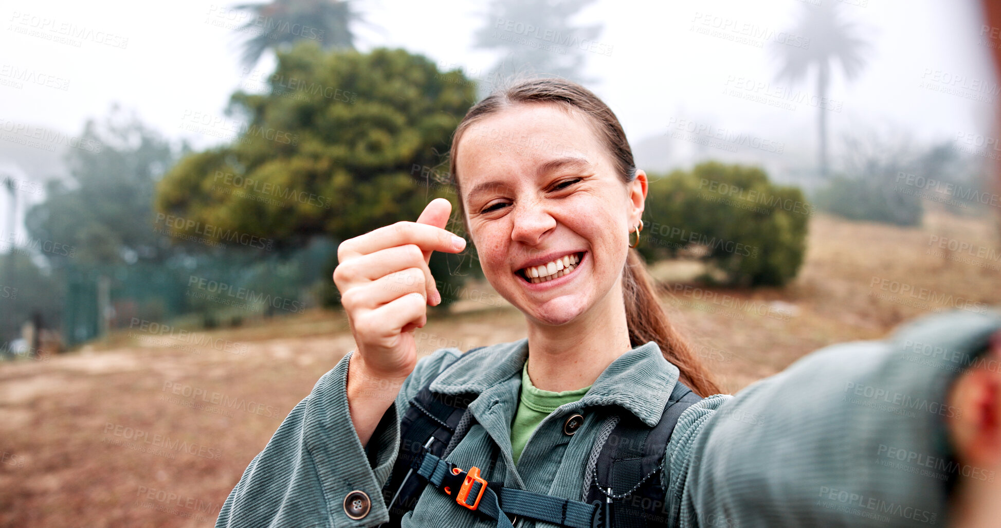 Buy stock photo Hiking, selfie and finger hearts with woman in nature for social media, travel and adventure. Photography, trekking and environment with portrait of person for eco tourism, backpacking and vacation