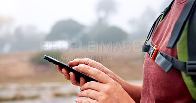 Buy stock photo Hands, phone and hiking in nature with search for direction, location and outdoor with scroll at river. Person, smartphone and click on mobile app with digital map, landmark or tourism in countryside
