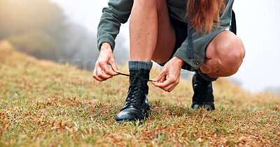 Buy stock photo Boots, hiking and woman tie laces outdoor for activity, exploring or adventure on holiday. Fitness, hands and closeup of female person getting ready with shoes for trekking in nature for exercise.