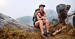 Girl, hiking and getting cold on mountain in winter, thinking and fatigue with weather change, fog and tourism. Person, woman and trekking on tree trunk, exhausted and tired on adventure in Argentina