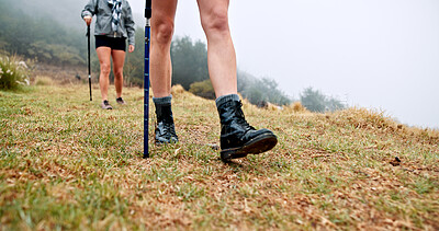Buy stock photo Trekking pole, feet and walking on mountain for travel adventure, cardio workout and expedition. Fitness, shoes of people and hiking with balance outdoor for holiday exploration, exercise or wellness