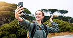 Hiking, video call and travel with woman in nature for streaming, smile and adventure. Virtual chat, trekking and environment with person and mobile for eco tourism, backpacking and vacation