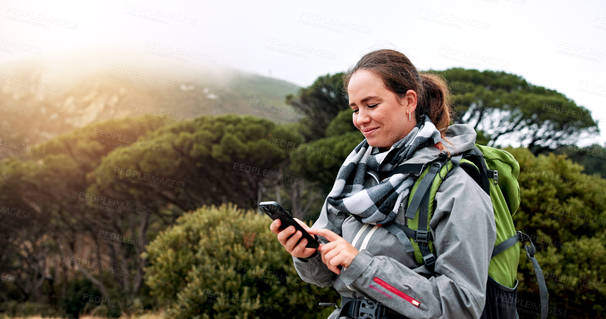 Buy stock photo Hiking, phone and scroll with woman in nature for social media post, travel and adventure. Communication app, trekking and environment with person outdoor for eco tourism, backpacking and vacation