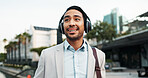 Business, man and walking with headphones in city for morning commute, music playlist and streaming audio. Professional, person and smile outdoor for sound track, corporate podcast and work travel