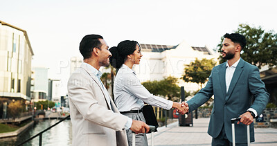 Buy stock photo Business people, meeting and career opportunity with handshake for travel, commute or deal in city. Group, employees or team shaking hands with partnership for B2B, negotiation or agreement in town