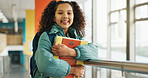 School, hallway and portrait of girl with books walking for studying, classroom and learning. Students, campus and kids in corridor with backpack for education, academy and knowledge in morning