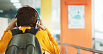 Headphones, walking and back of boy at school with backpack for education, autism development and growth. Listening, streaming subscription and child student at academy with music app, audio and kids
