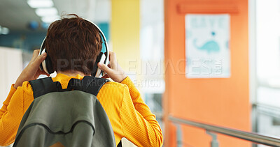 Buy stock photo Headphones, walking and back of boy at school with backpack for education, autism development and growth. Listening, streaming subscription and child student at academy with music app, audio and kids