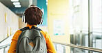 Headphones, walking and back of child at school with backpack for education, autism development and growth. Listening, streaming subscription and boy student at academy with music app, audio and kids