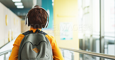 Buy stock photo Headphones, walking and back of child at school with backpack for education, autism development and growth. Listening, streaming subscription and boy student at academy with music app, audio and kids