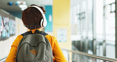 Buy stock photo Headphones, walking and back of kid at school with backpack for education, autism development and growth. Listening, streaming subscription and boy student at academy with music app, audio and child