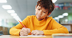 Thinking, learning and kid writing on paper for exam, test or problem solving for knowledge in class. Pencil, boy or student at school for education, development or study for assessment with solution