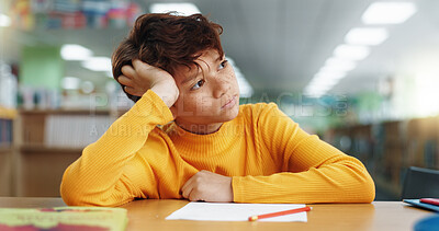 Buy stock photo Thinking, boy and student in library at school for planning, ideas and studying of learning solution. Bored, kid and lazy child with thoughts of education burnout, problem solving and exam reflection
