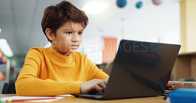 Buy stock photo Boy, child and typing with laptop for elearning, online education or browsing in school library. Learner, student or kid on computer for elementary project, academic research or childhood development