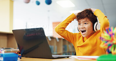 Buy stock photo Happy child, student or good news with laptop for winning, elearning or grade results in library. Boy, kid or excited learner with wow, headphones or computer for online score or educational progress