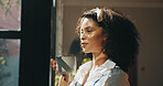 Coffee, thinking and African woman by window with ideas, inspiration and daydreaming in home. Relax, morning break and person in living room with drink for reflection, wellness and rest on weekend