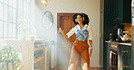 Headphones, woman and dancing to music in home for weekend break, audio playlist or streaming sound. Happy, african person and fun with album track, listening to radio and media podcast with sunlight