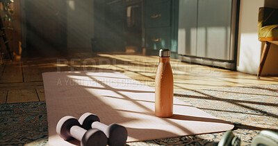 Buy stock photo Fitness, gym equipment and water bottle with yoga mat at home for dumbbell, workout an health routine. Empty room, training and weights on floor of apartment for exercise, pilates and wellness