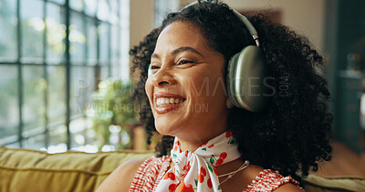 Buy stock photo Thinking, music and happy woman with headphones on sofa, streaming podcast and subscription. Home, audio technology and African person listening to radio, reflection or idea for playlist to relax