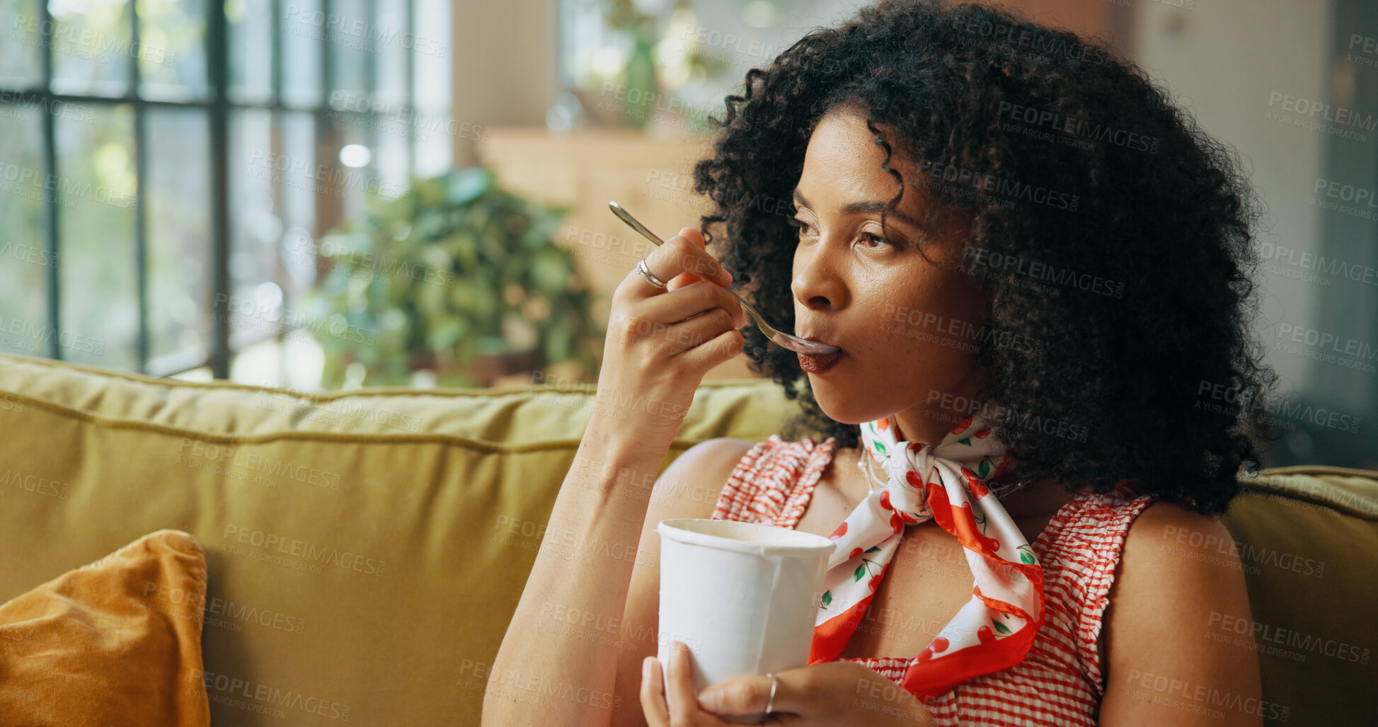 Buy stock photo Eating, ice cream and woman on sofa in home with bowl for dessert, sweet treat and enjoy food. Apartment, living room and African person with craving for frozen yogurt, snack and gelato for PMS