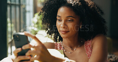 Buy stock photo Morning, phone and African woman on sofa in home for social media, networking and communication. Happy, living room and person on smartphone for online chatting, internet post or website on weekend