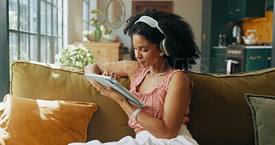 Buy stock photo Tablet, headphones and woman on sofa for music, streaming song or audiobook in home. Living room, technology and African person listening to radio, podcast and sound for playlist on internet to relax