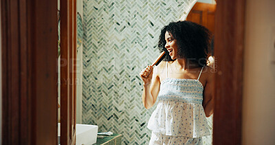 Buy stock photo Woman, brush and singing with humor in bathroom for playful, concert and voice for morning routine in home. African person, hair care and happy with karaoke, song and funny performance at apartment