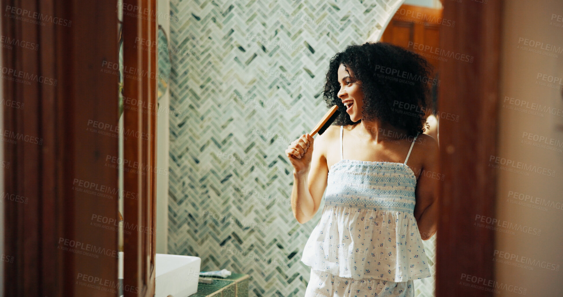 Buy stock photo Woman, brush and singing with humor in bathroom for playful, concert and voice for morning routine in home. African person, hair care and happy with karaoke, song and funny performance at apartment