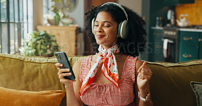 Buy stock photo Mobile, music and woman dance on sofa, streaming sound and subscription for song in home. Headphones, phone and happy African person listening to radio, album and audio playlist on internet to relax